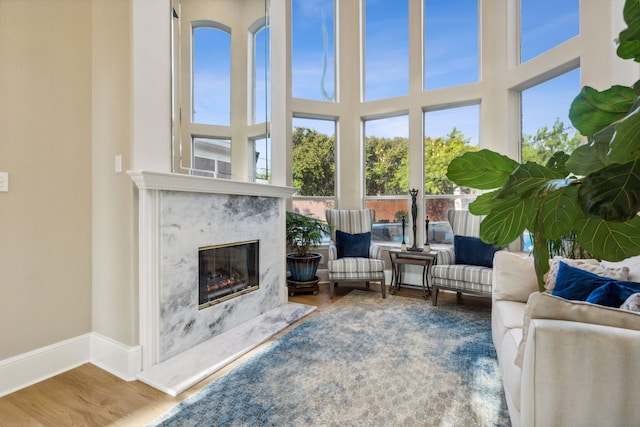 sunroom / solarium featuring a premium fireplace