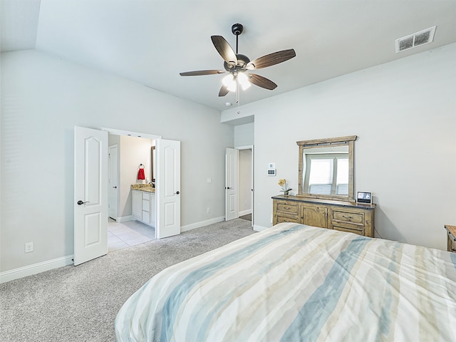 carpeted bedroom featuring connected bathroom, ceiling fan, and vaulted ceiling