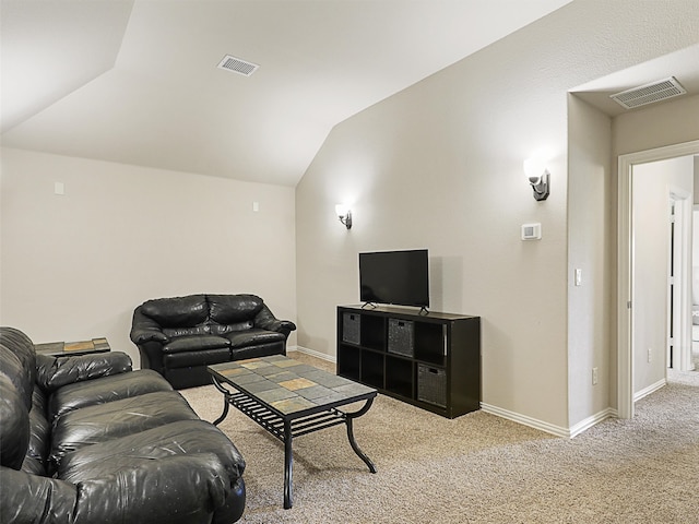 carpeted living room with vaulted ceiling