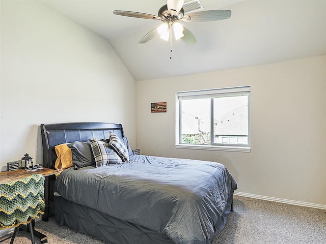 carpeted bedroom with ceiling fan and vaulted ceiling