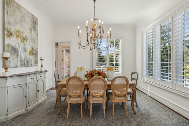 carpeted dining area with a wealth of natural light and an inviting chandelier