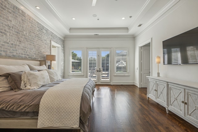 bedroom with dark hardwood / wood-style flooring, access to outside, a tray ceiling, crown molding, and french doors