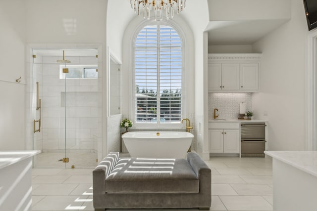 bathroom with vanity, a notable chandelier, tile patterned floors, and separate shower and tub