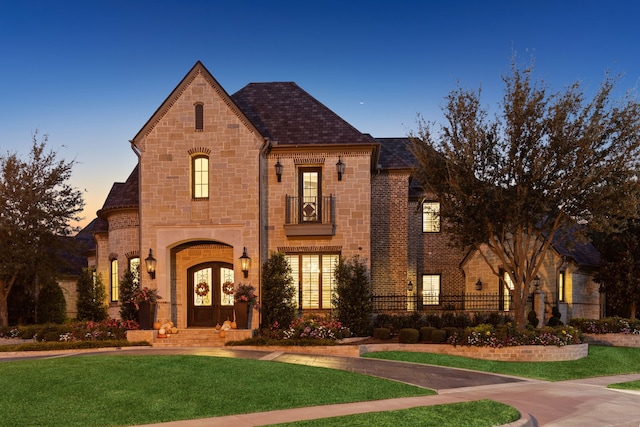 french provincial home featuring a yard