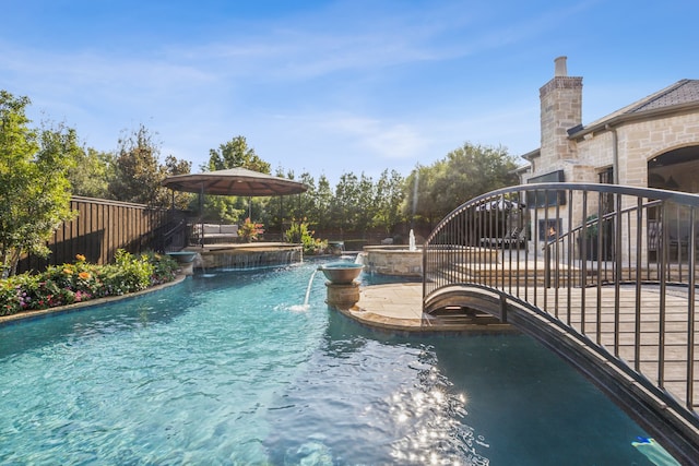6408 Drawbridge Ln, Plano, TX 75024 - view of swimming pool with a pool with connected hot tub and fence