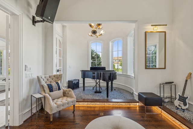 sitting room featuring a notable chandelier and dark hardwood / wood-style floors