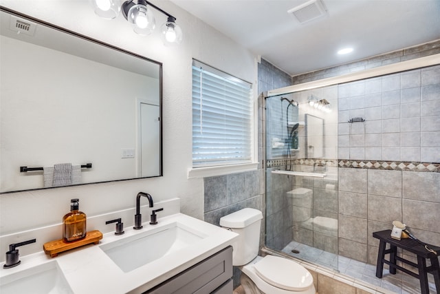 bathroom featuring vanity, toilet, and an enclosed shower