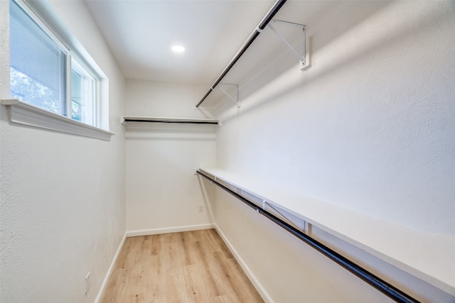 spacious closet with light hardwood / wood-style floors