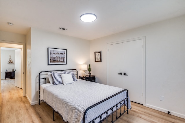 bedroom with a closet and light wood-type flooring