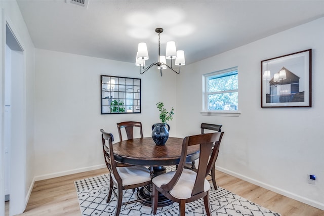 dining room featuring a chandelier and light wood-type flooring