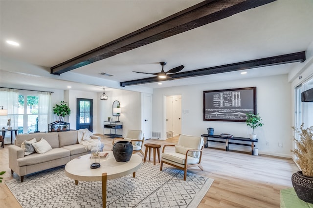 living room featuring beam ceiling, light hardwood / wood-style floors, and ceiling fan