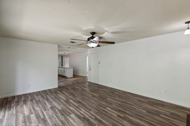 unfurnished living room with a textured ceiling, dark hardwood / wood-style flooring, and ceiling fan