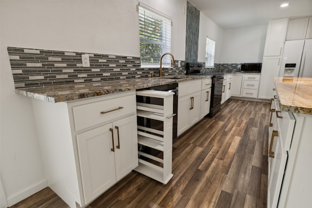 kitchen with decorative backsplash, dark hardwood / wood-style flooring, stone counters, white cabinets, and black electric range oven