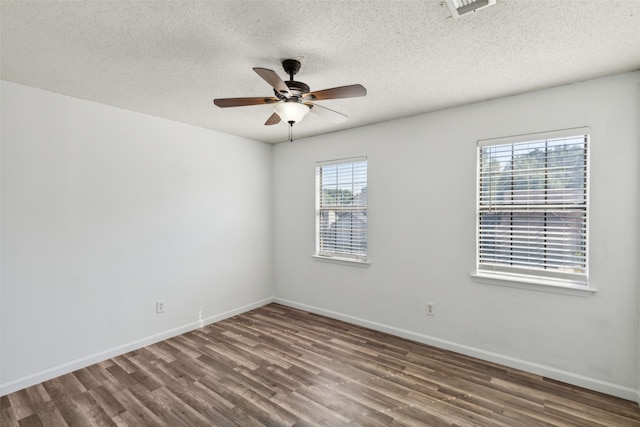 spare room with a textured ceiling, ceiling fan, and dark hardwood / wood-style floors