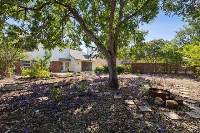 view of yard with a fire pit