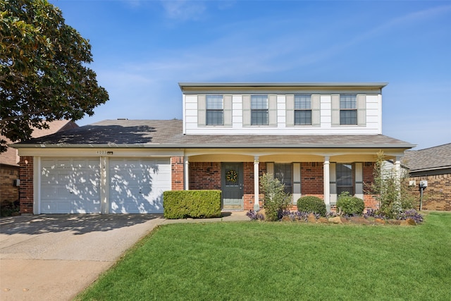 front of property featuring a front yard, a porch, and a garage