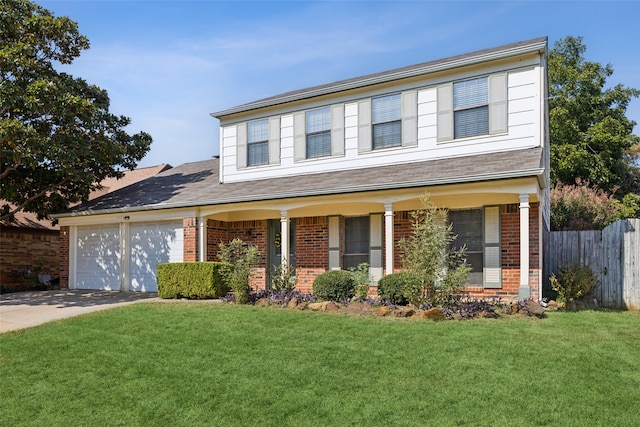 view of front of property with covered porch, a garage, and a front lawn