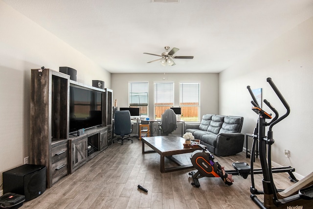 living room with light wood-type flooring and ceiling fan