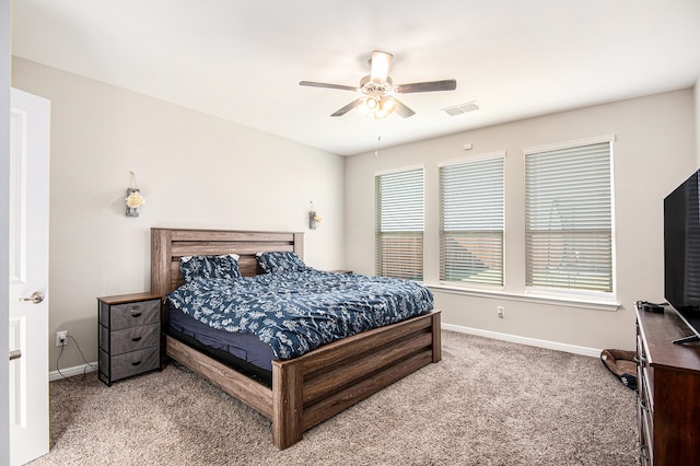 carpeted bedroom with multiple windows and ceiling fan