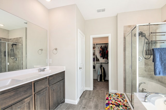 bathroom with vanity, wood-type flooring, and separate shower and tub