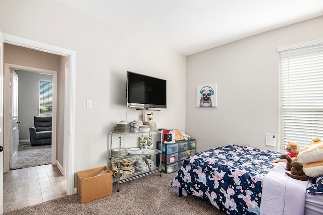 bedroom featuring hardwood / wood-style floors and multiple windows