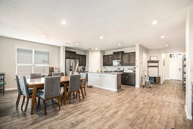 dining room with sink and light hardwood / wood-style floors