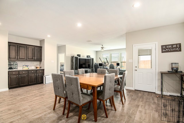 dining space featuring light wood-type flooring and ceiling fan