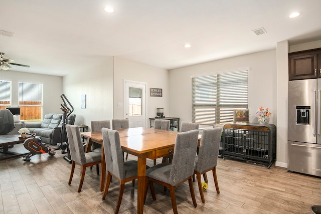 dining room with light hardwood / wood-style floors and ceiling fan