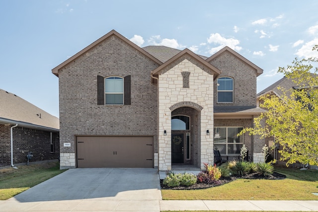 french provincial home with a front lawn and a garage