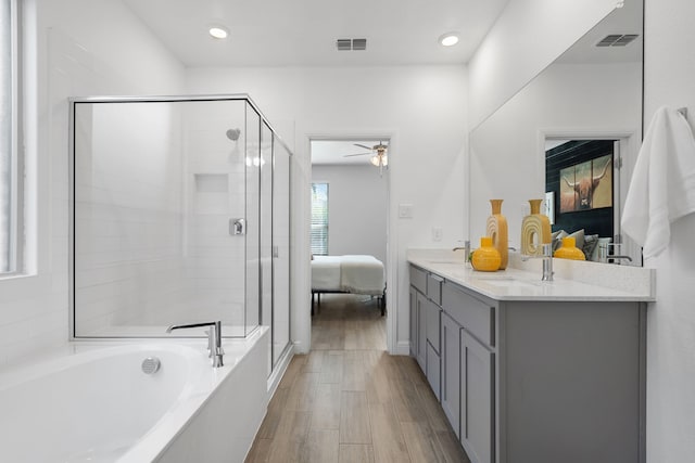 bathroom featuring vanity, separate shower and tub, and hardwood / wood-style floors