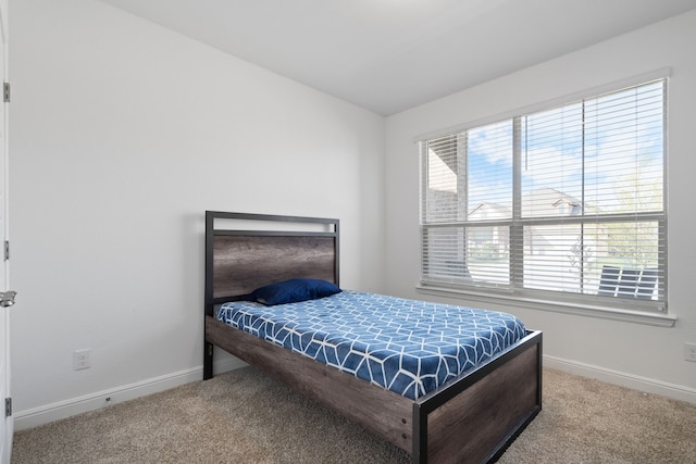 bedroom with multiple windows and carpet floors