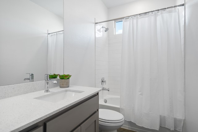 full bathroom with vanity, shower / bath combo with shower curtain, and toilet