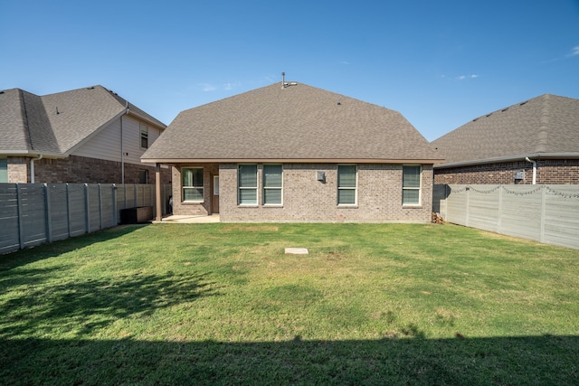 back of house featuring a yard