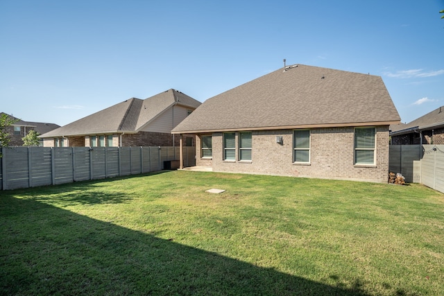 back of property featuring a lawn