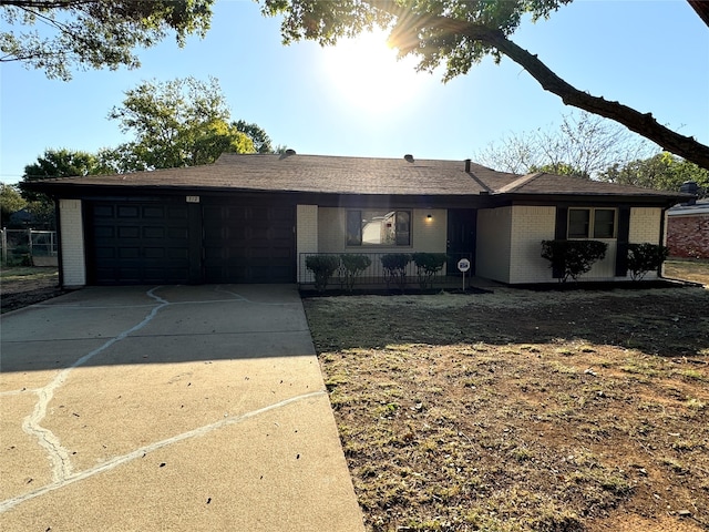 ranch-style home with a garage and a porch