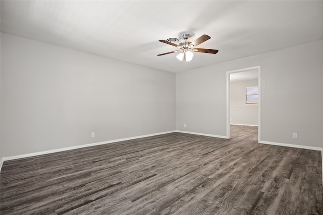 empty room featuring dark wood-type flooring and ceiling fan