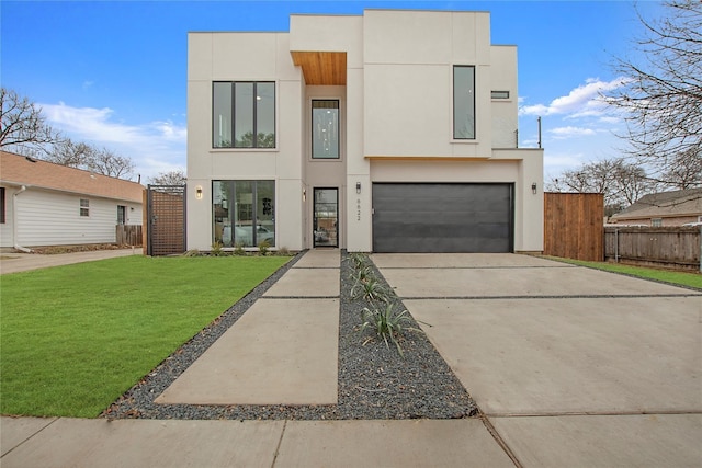 modern home featuring a front yard and a garage