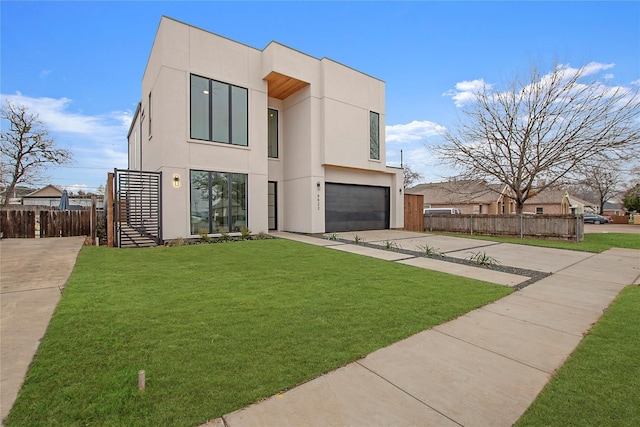 contemporary home with a front yard and a garage