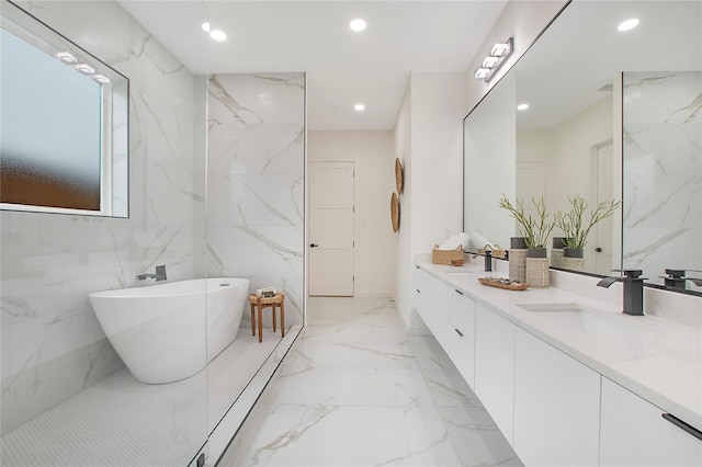 bathroom featuring vanity, tile walls, and a washtub