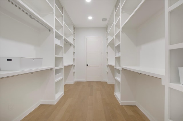 spacious closet featuring light hardwood / wood-style flooring