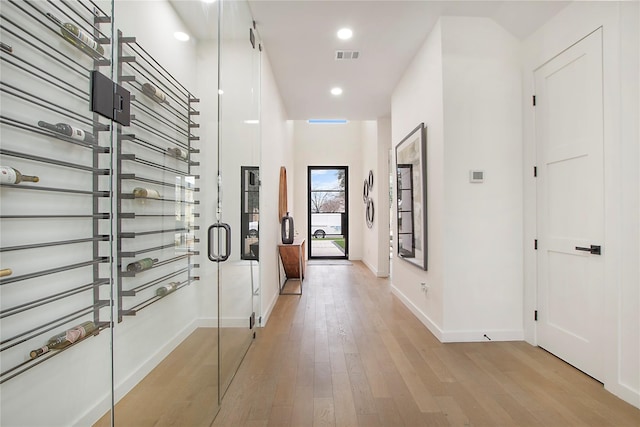 corridor with light hardwood / wood-style flooring