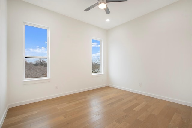 spare room featuring light hardwood / wood-style floors and ceiling fan