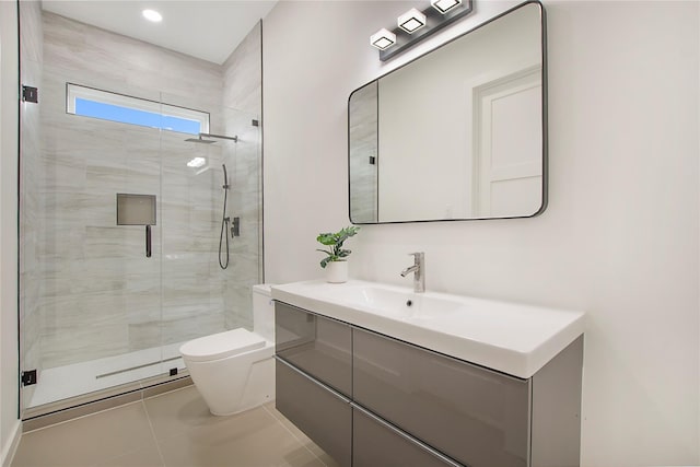 bathroom with vanity, a shower with shower door, toilet, and tile patterned floors