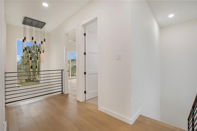 corridor with light hardwood / wood-style flooring