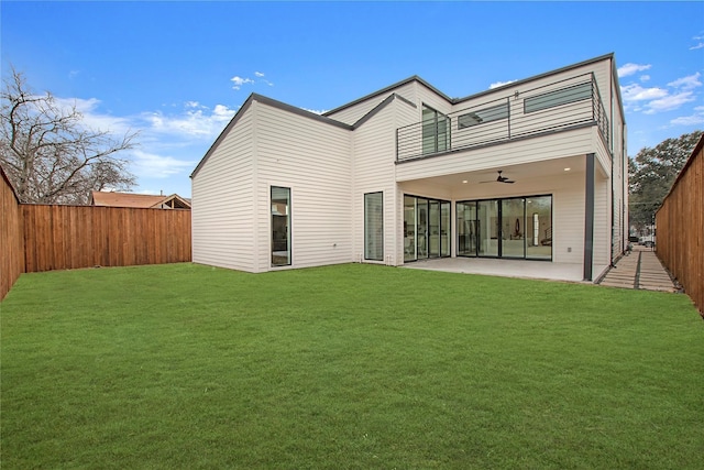 back of house with a patio, a lawn, and ceiling fan