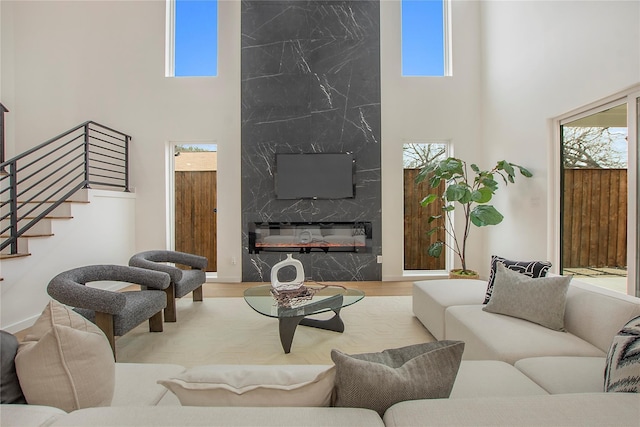 living room with a towering ceiling and plenty of natural light