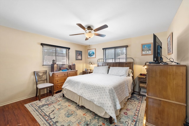 bedroom featuring ceiling fan, multiple windows, and hardwood / wood-style floors