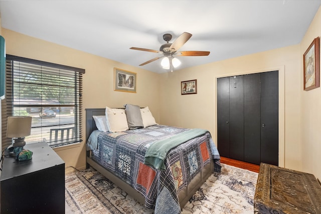 bedroom with light wood-type flooring, a closet, and ceiling fan