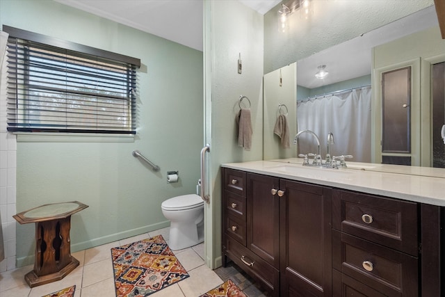 bathroom with vanity, toilet, and tile patterned floors