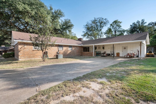 231 La Jolla Dr, Athens, TX 75751 - view of front facade featuring driveway, central AC, a chimney, brick siding, and a front lawn